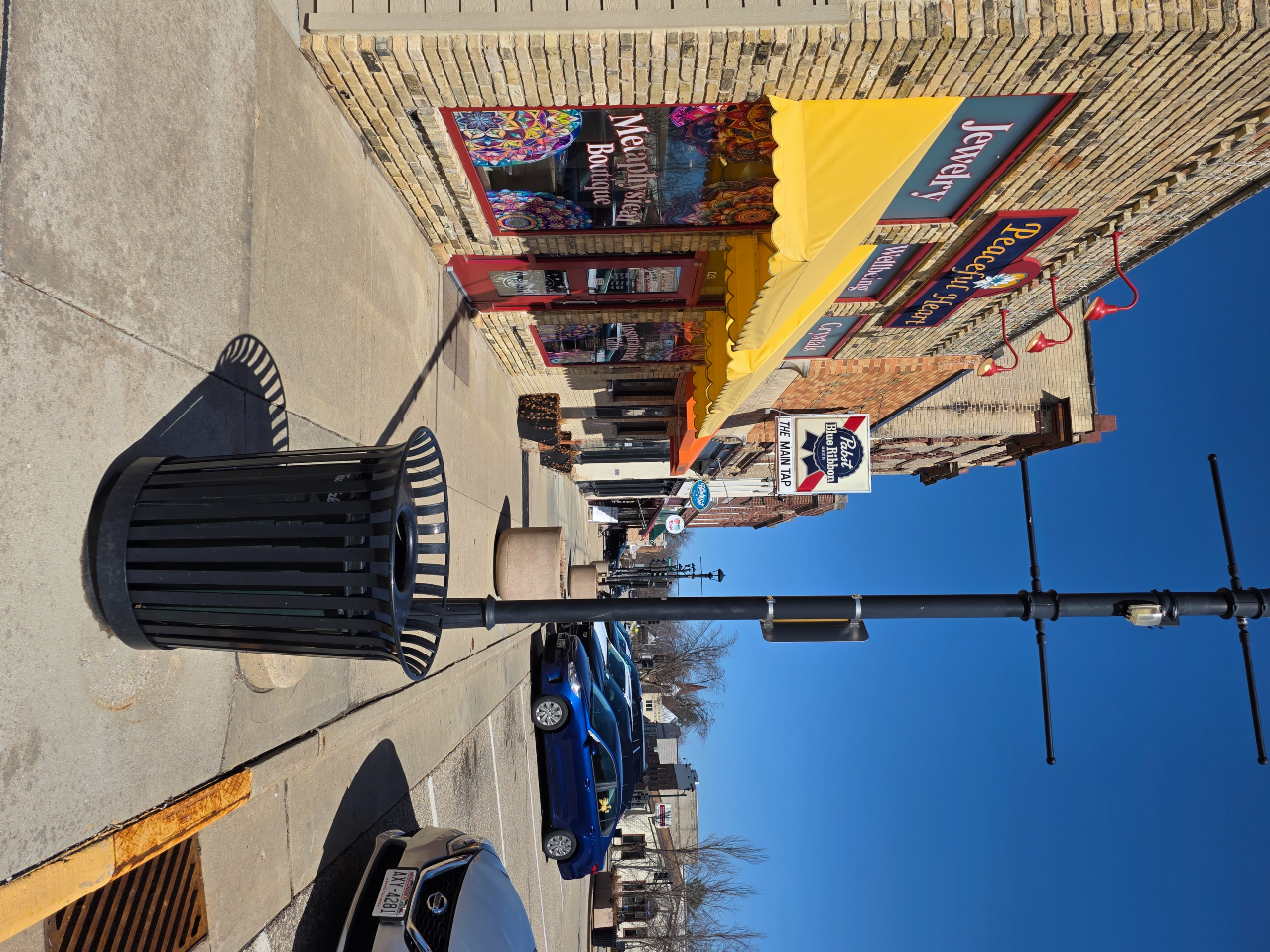 Junk removal service in Oregon, WI — downtown main street with local shops and brick buildings